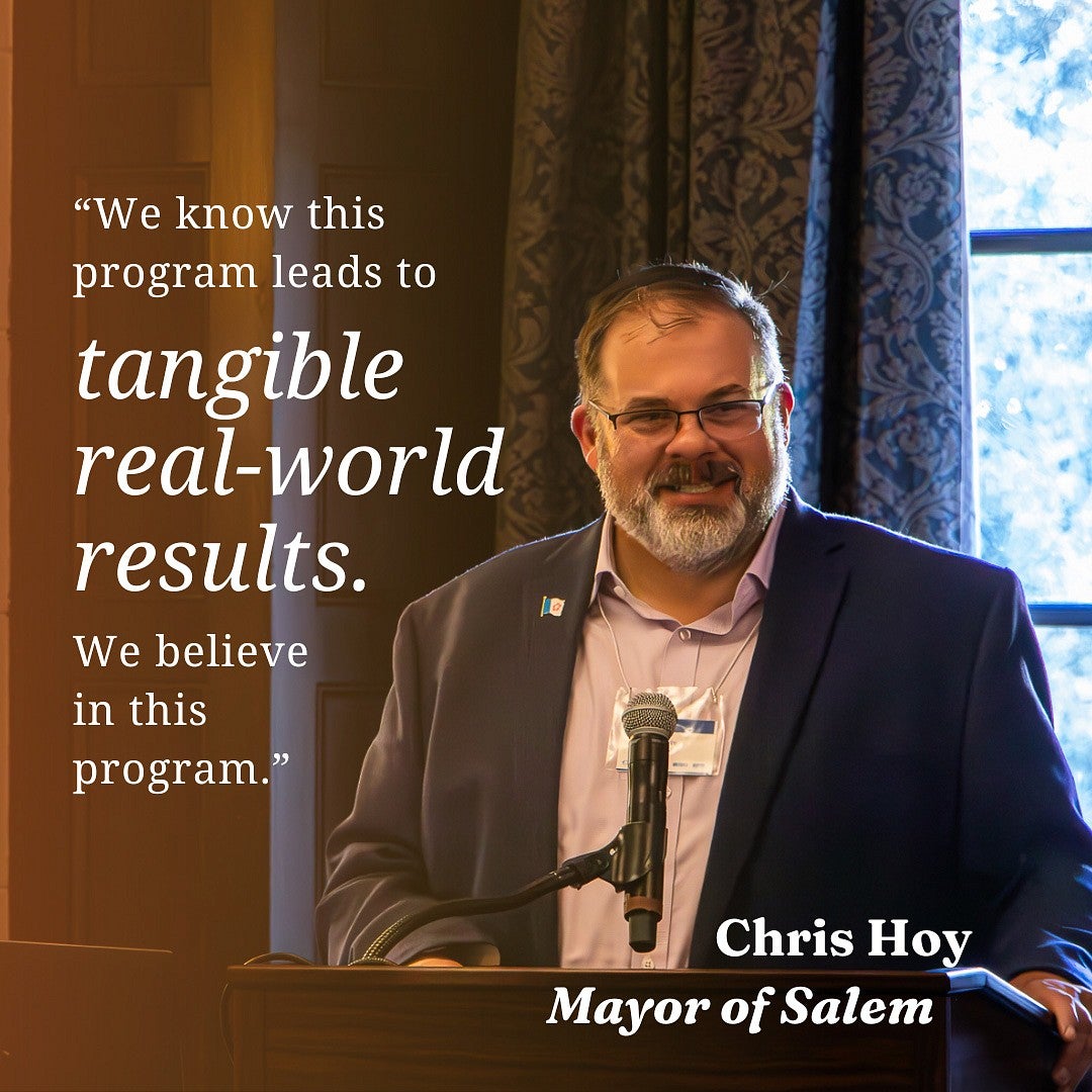 Salem Mayor Chris Hoy stands behind podium and smiles