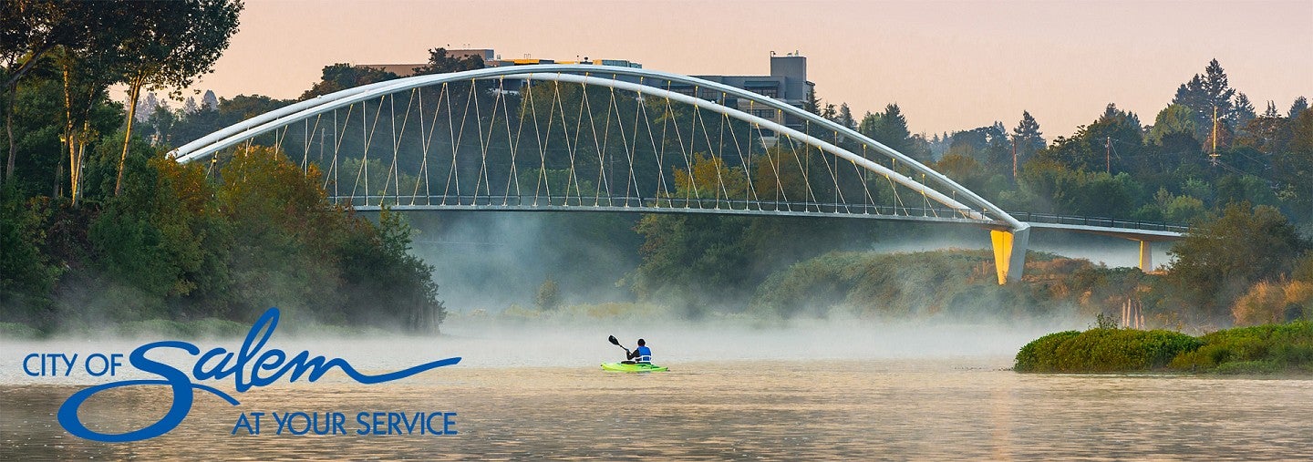 Man kayaks in Salem's Riverfront Park, with Salem logo overlay