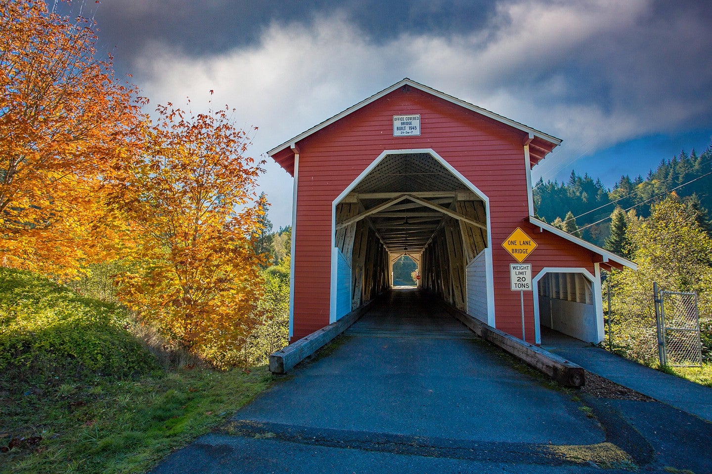 Covered bridge in Oakridge, Oregon with autumn trees surrounding it