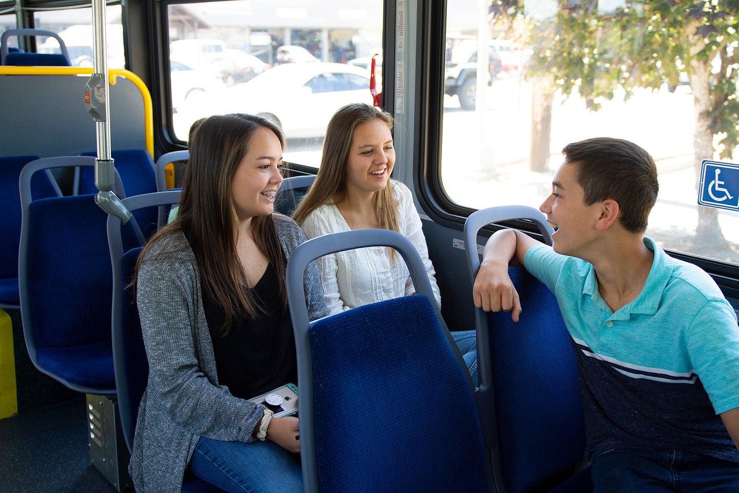 Kids on bus smile and chat with each other