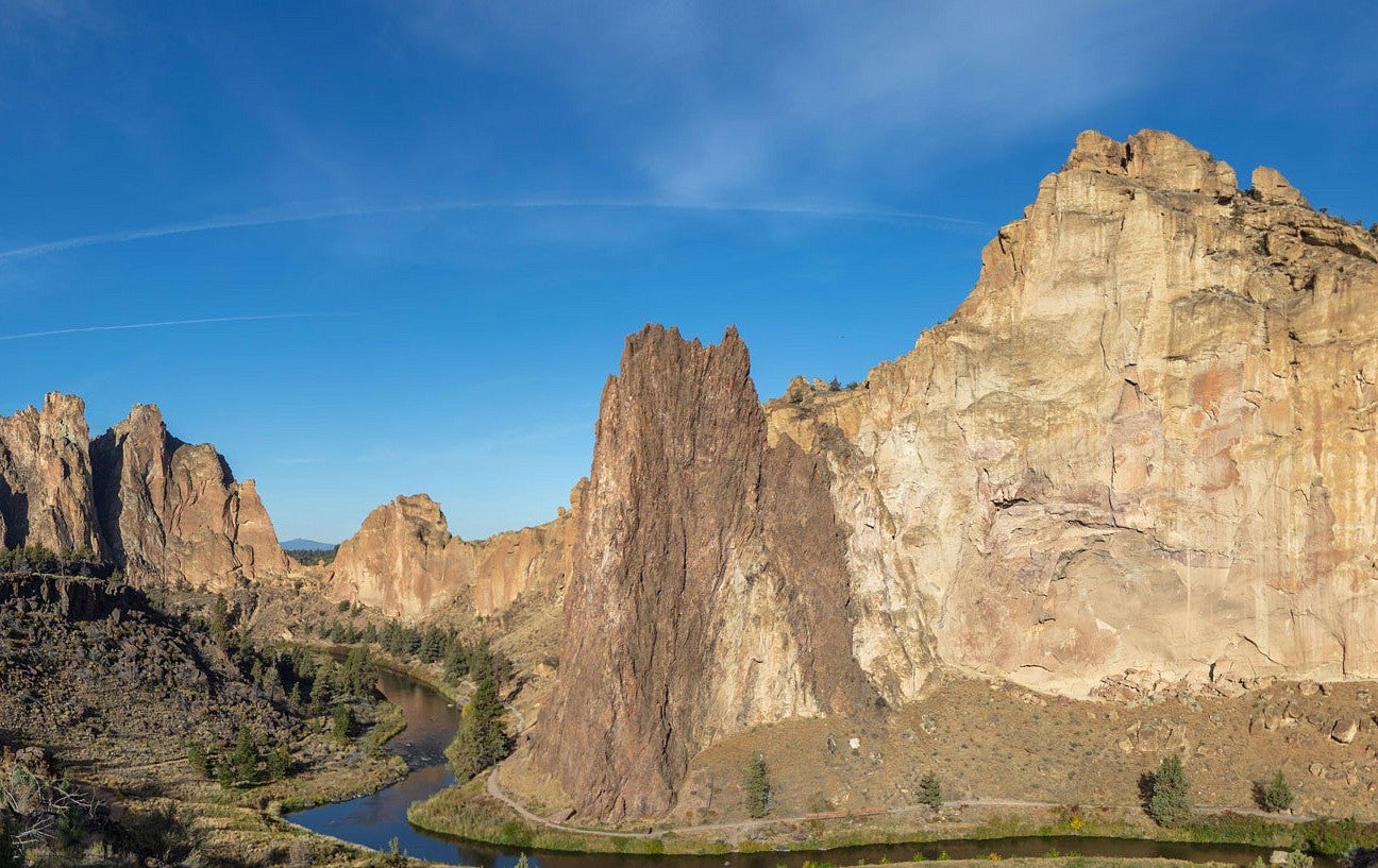 Tall cliffs overlooking a ravine and some trees