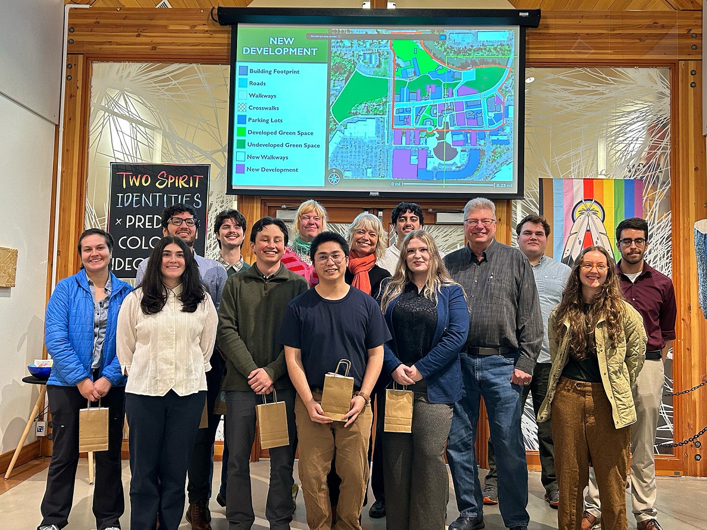 Students and faculty pose in front of final presentations