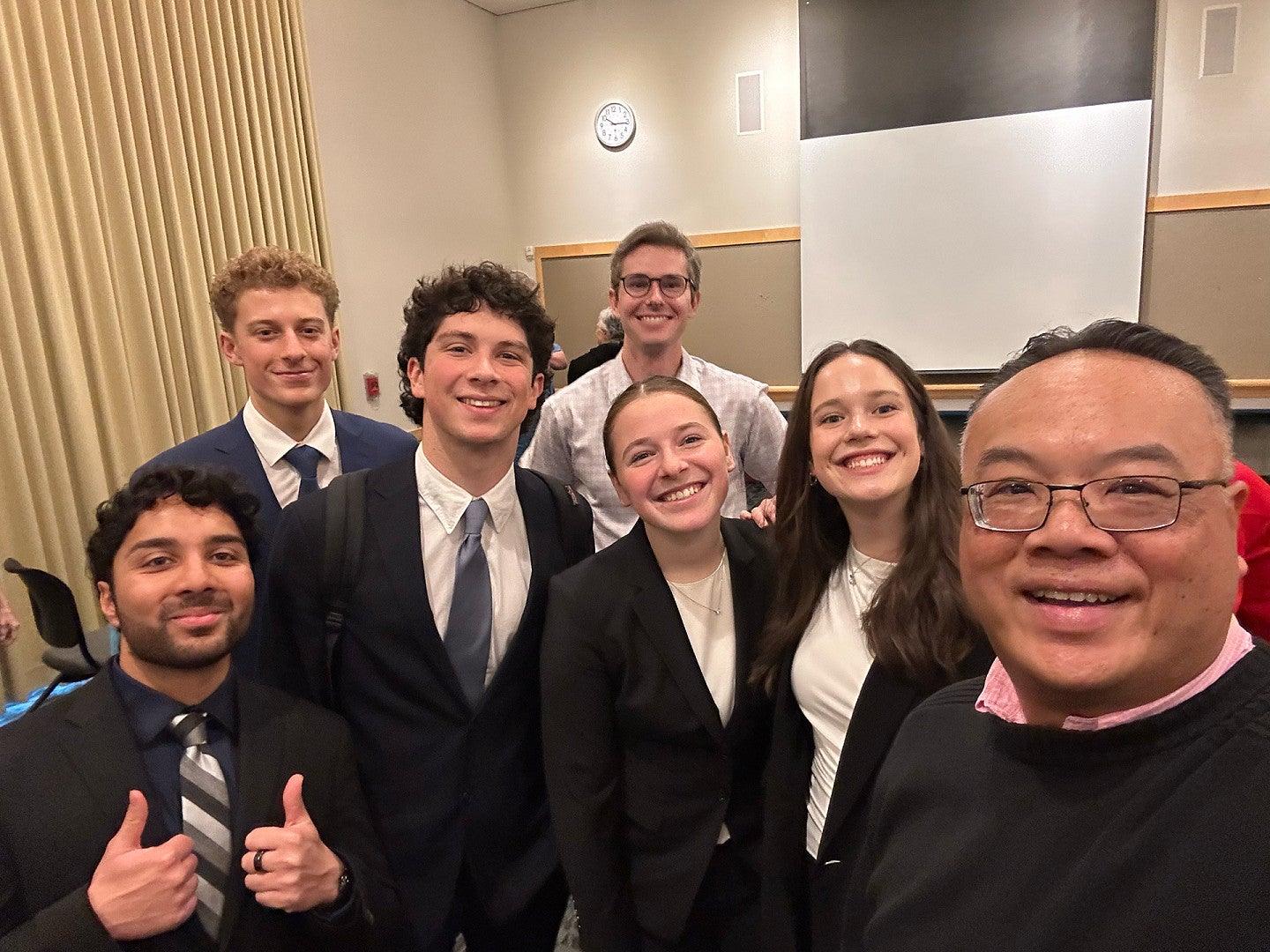 Students and faculty pose for selfie