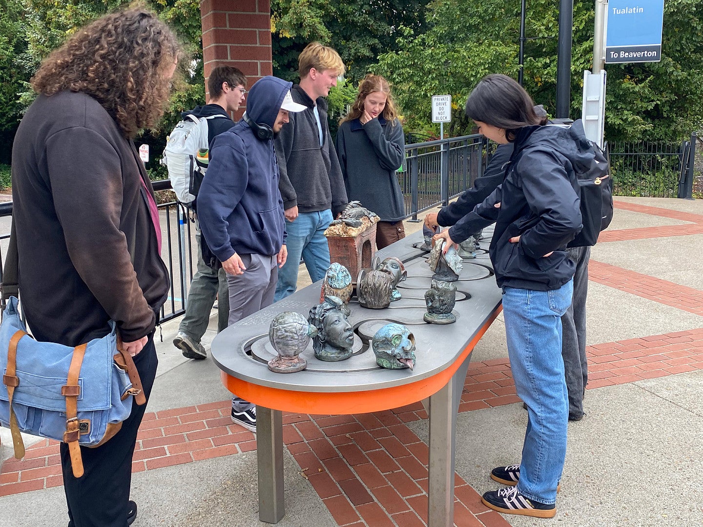 Students on site visit interacting with art installation