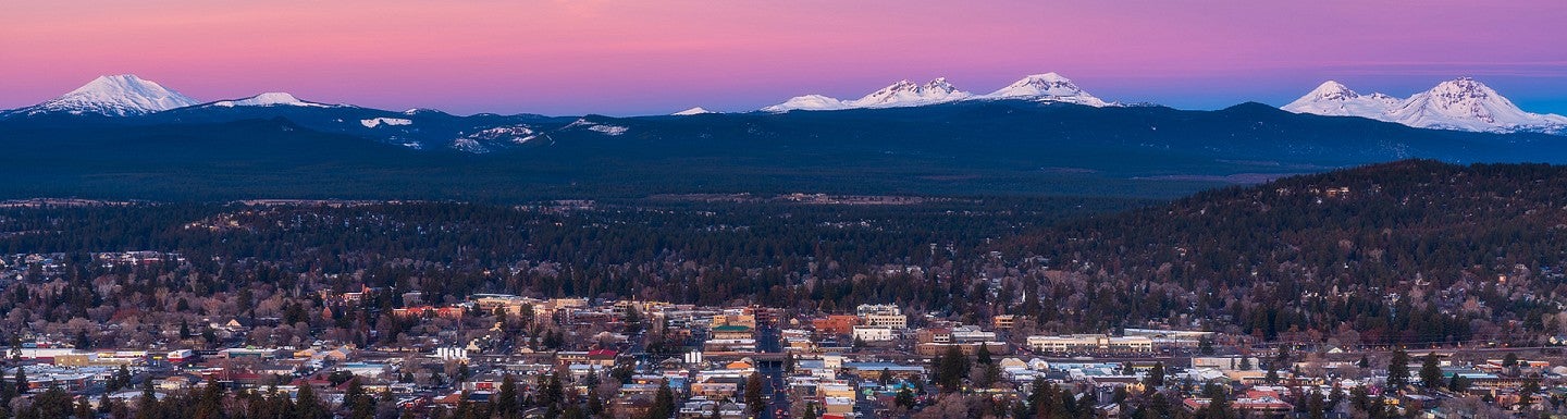 Bend, Oregon cityscape with mountains in the background
