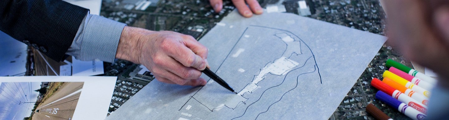 Students work on charrettes over a city map