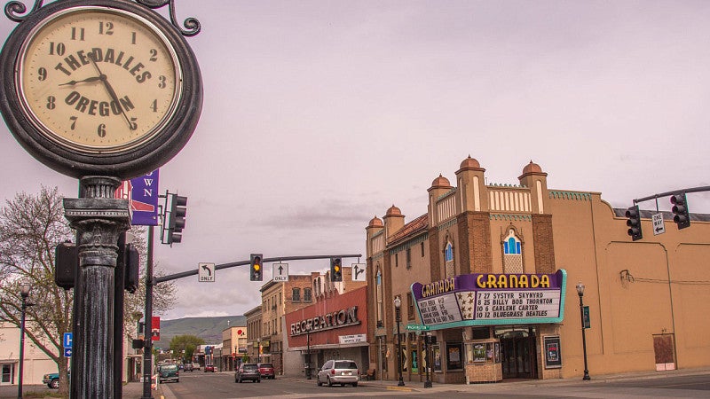 Street view of city with clock and music venue