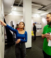 UO architecture major Jamaica Atad shares her Oakridge affordable housing ideas with Eugene architect Douglas Murkley during a studio review session where students get feedback from professionals