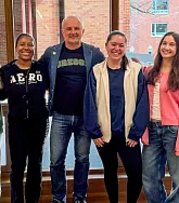 Students and professor smile together