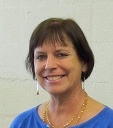 Headshot of Marsha Graveson smiling in front of white wall